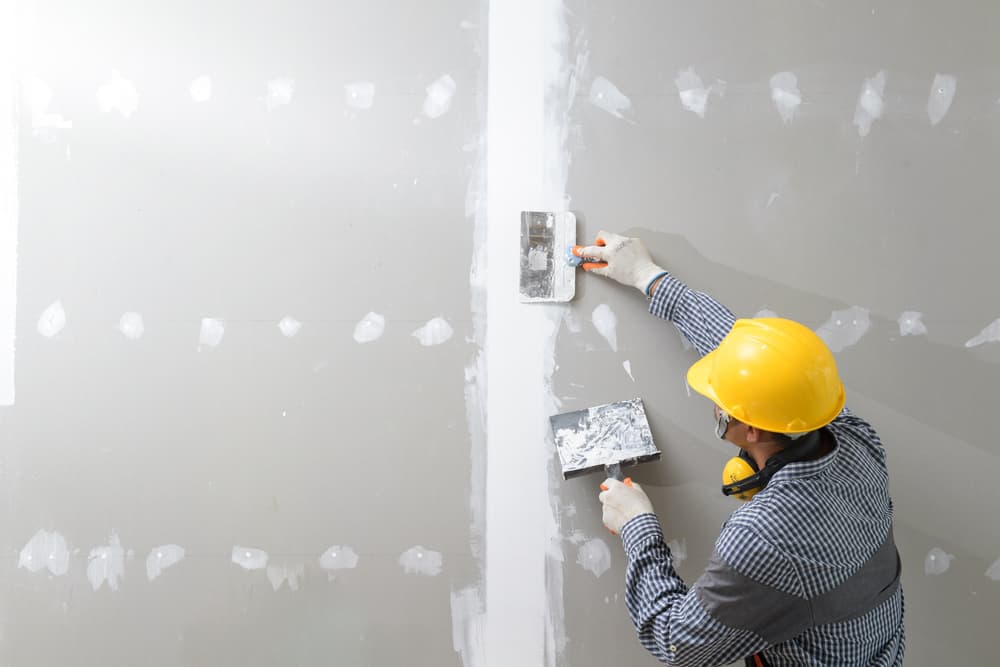 contractor spackling drywall.